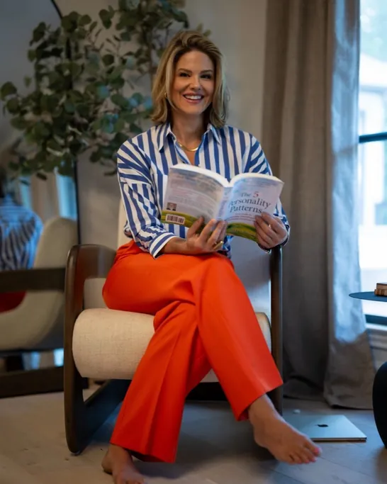 Brittany Watkins reading in an armchair