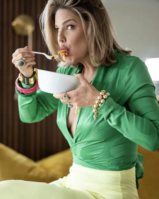 Brittany Watkins in a green top eating a bowl of pasta